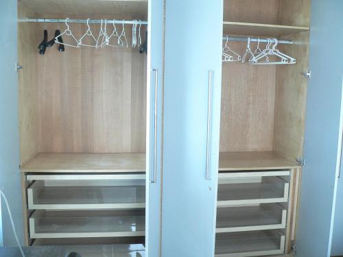 a walk in closet with wooden cabinets and shelves at Liège centre 13 Quai Godefroid Kurth POUR 2 PERS à 25 min gare Guillemins in Liège