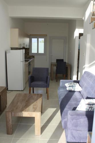 a living room with a couch and a table at Suluca Homes in Kérynia