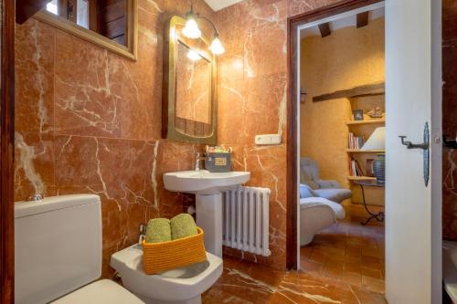 a bathroom with a toilet and a sink and a mirror at Can Felip Apartments in Palafrugell