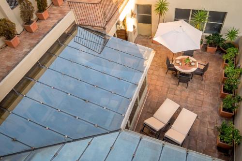 an overhead view of a patio with a table and an umbrella at Can Felip Apartments in Palafrugell