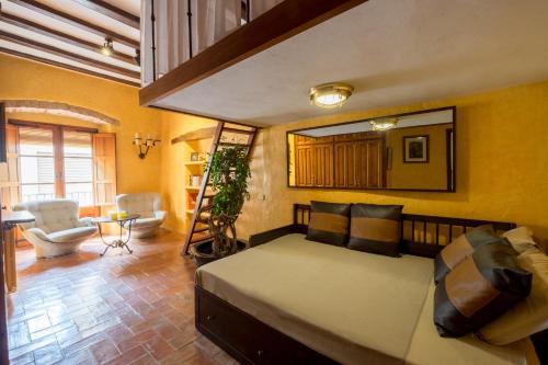 a bedroom with a large bed and a bathroom at Can Felip Apartments in Palafrugell