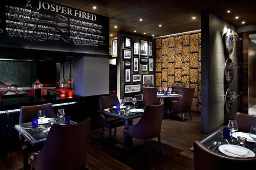 a restaurant with tables and chairs and a menu at Sankara Nairobi, Autograph Collection in Nairobi