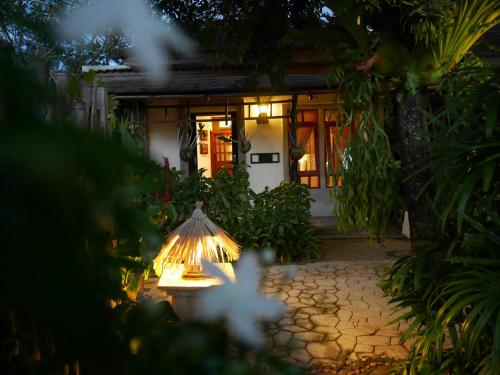 a lit up lamp in front of a house at Bangtao Beach Chalet Resort in Bang Tao Beach