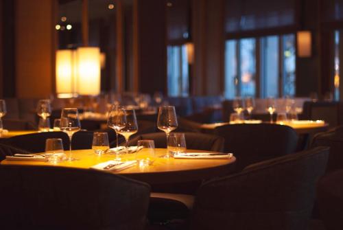 a group of tables with wine glasses on them at Louis Hotel in Munich