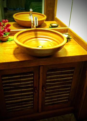 a bathroom sink with a large bowl sink at Pousada Vila Araticum in Santo André