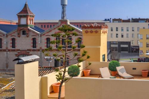 a tree on the roof of a building at Can Felip Apartments in Palafrugell