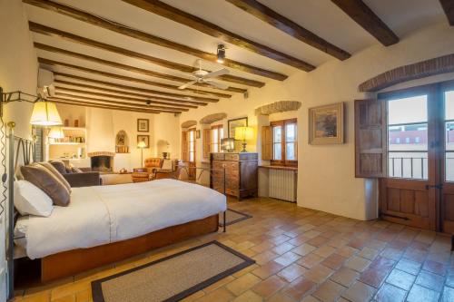 a bedroom with a large bed and a living room at Can Felip Apartments in Palafrugell
