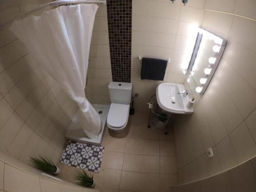 a small bathroom with a toilet and a sink at Apartamento a primera linea de mar en platja d’aro in Platja  d'Aro