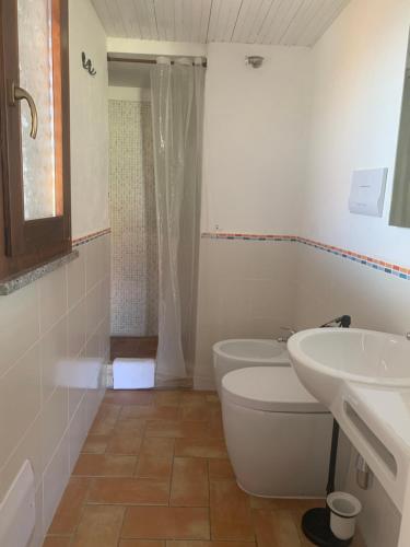 a bathroom with a toilet and a sink at Locanda FarOrientale in Santa Lucia