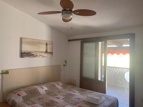 a bedroom with a bed and a ceiling fan at Locanda FarOrientale in Santa Lucia