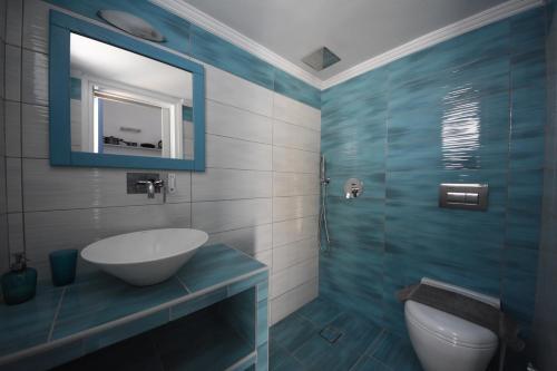 a bathroom with a sink and a mirror at Panos Studios in Masouri