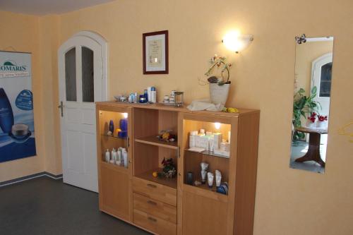 a room with a wooden shelf with products on it at Villa Jagdhaus in Wernigerode