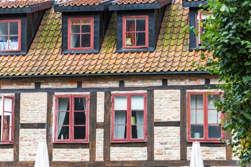a building with red windows and a roof at Continental Apartment Hotel Helsingborg in Helsingborg