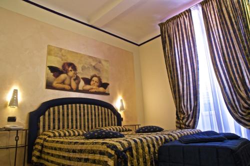 a bedroom with a bed and a painting on the wall at Hotel La Luna in Lucca
