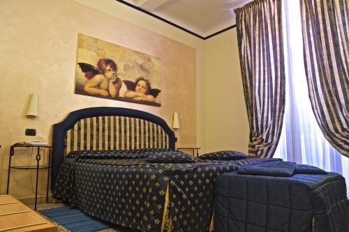 a bedroom with a bed and a painting on the wall at Hotel La Luna in Lucca