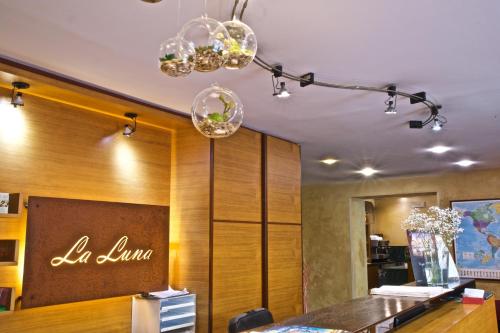 a dining room with a table and a chandelier at Hotel La Luna in Lucca