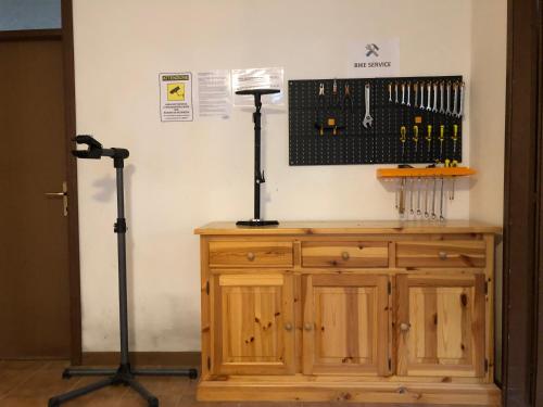 a room with a wooden cabinet with two microphones at Hotel Villa Al Vento in Nago-Torbole