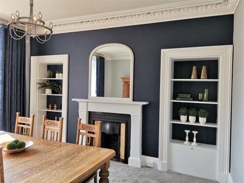 a dining room with a table and a fireplace at No 48 Castle View in Inverness