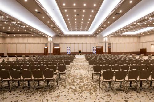 a large room with rows of chairs in it at Ramada Jerusalem Hotel in Jerusalem