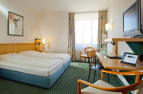 Postel nebo postele na pokoji v ubytování HKK Hotel Wernigerode
