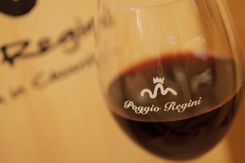 a close up of a glass of red wine at AZ.AGR.POGGIO REGINI in Castellina in Chianti
