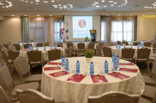 a conference room with tables and chairs with water bottles at Ramada Jerusalem Hotel in Jerusalem