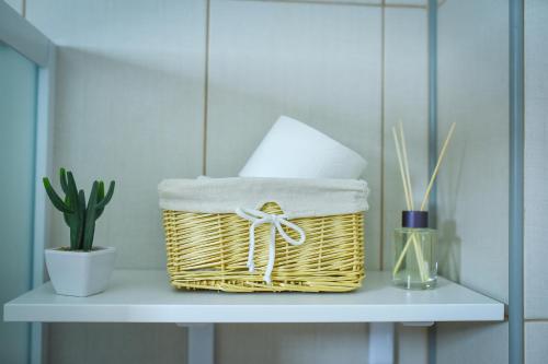 a wicker basket sitting on a shelf with a plant at Urban Apartment in Niš