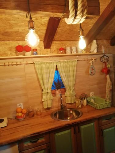 a kitchen counter with a sink and a window at Vikendica RANKOVIĆI in Mokra Gora
