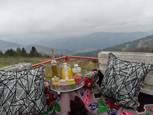 a table with bottles of alcohol on top of a mountain at Vikendica RANKOVIĆI in Mokra Gora