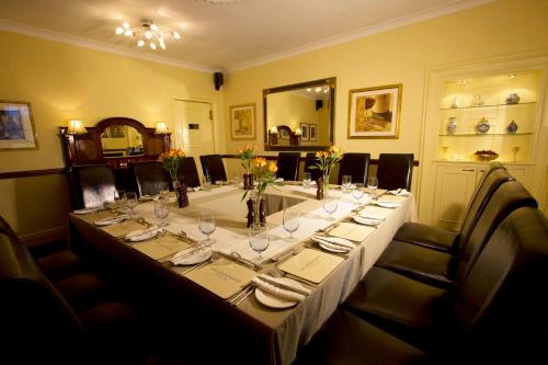 a long table with glasses and vases on it at The Wheatsheaf Hotel and Restaurant in Swinton
