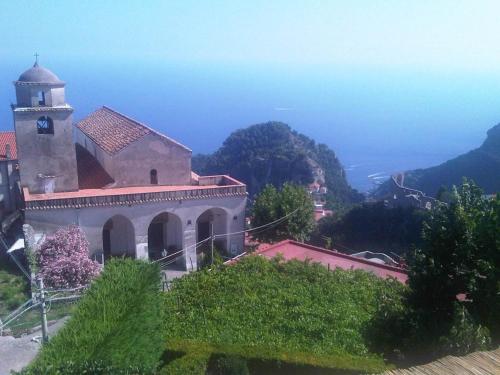 a church on a hill with a view of the ocean at Casa Falcone B&B in Scala