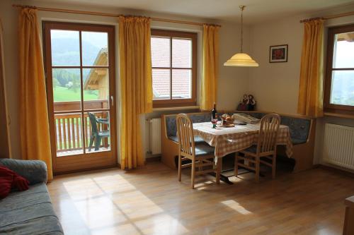 a dining room with a table and chairs and a balcony at Beikircherhof in San Lorenzo di Sebato