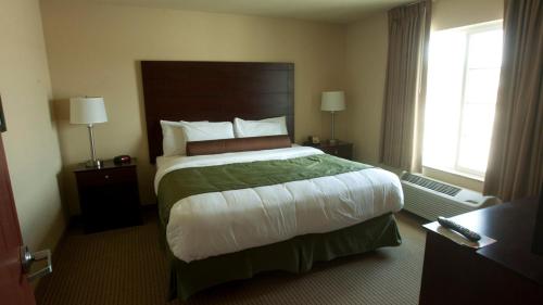 a bedroom with a large bed in a hotel room at Cobblestone Inn & Suites - Langdon in Langdon