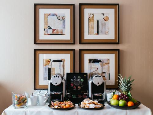 a table with plates of food and a coffee maker at Radisson Blu Style Hotel, Vienna in Vienna