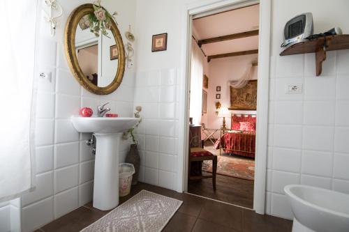 a bathroom with a sink and a mirror at Cittadella Rooms in Salerno