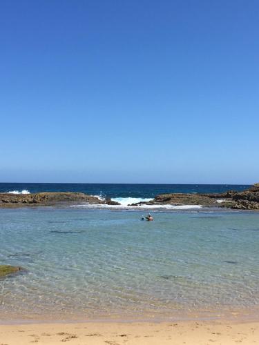 a person swimming in the ocean on a beach at Paradise Island in Isabela