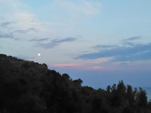 a view of a mountain with the moon in the sky at Villa Calamona in Acciaroli