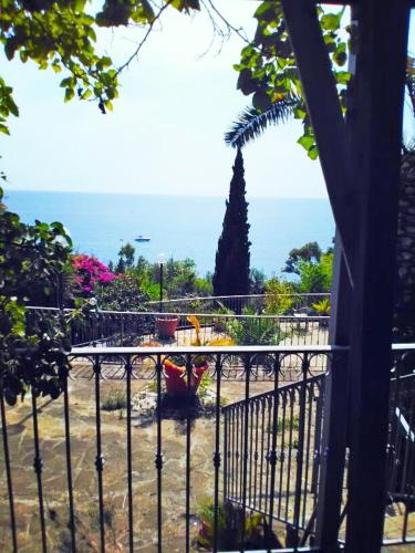 a wrought iron fence with a view of the ocean at Villa Calamona in Acciaroli