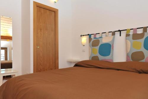 a bedroom with a bed with a brown blanket at Casa Falcone B&B in Scala