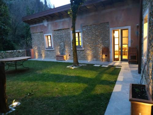 a patio of a house with a grass yard at Dimora Carducci in Pietrasanta