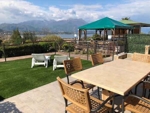 a patio with a table and chairs and a gazebo at Residence Bellavista in Manerba del Garda