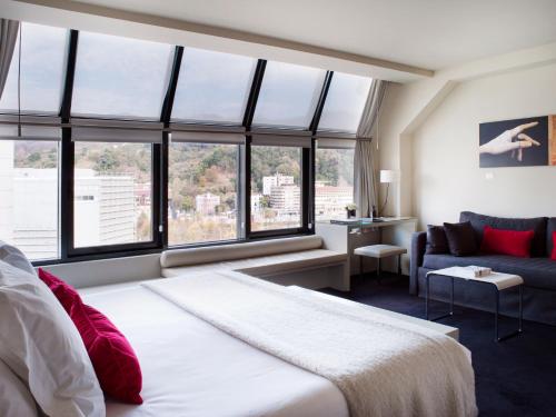 a hotel room with a bed and a window at Hotel Miró in Bilbao