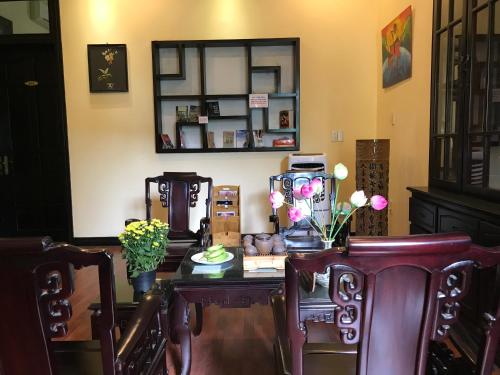 a room with a table with chairs and a mirror at Spring Garden Villa in Hue