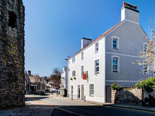 a white building on the side of a street at Number 18 in Conwy