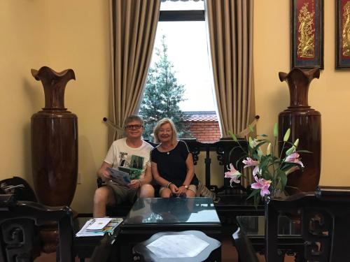 a man and a woman sitting in a room at Spring Garden Villa in Hue