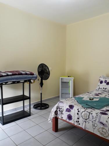 Säng eller sängar i ett rum på Pousada Alto do Morro