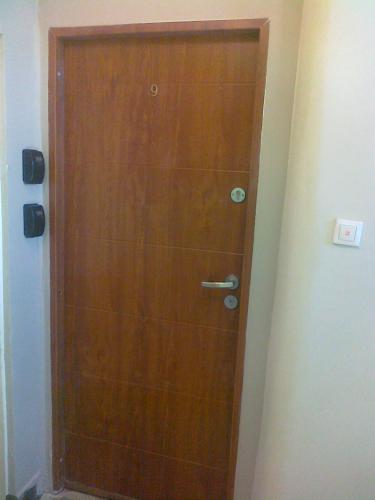 a wooden door in the corner of a bathroom at Gdynia99 in Gdynia