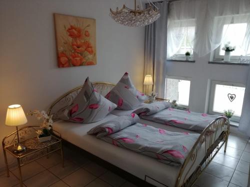 a bedroom with a bed with pillows on it at Apartament Paradise in Międzyzdroje