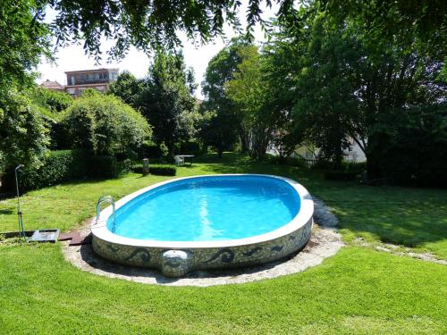 a large swimming pool in the grass in a yard at Casas do Toural in Gouveia