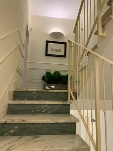 a hallway with stairs with a potted plant at B&B ALVINO in Bientina